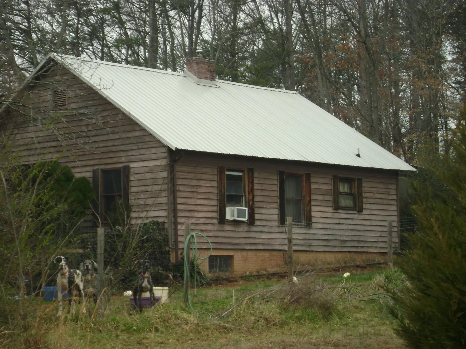 White metal roof on an old wood sided farmhouse, from a Metal Roof Installation job in Jasonville
